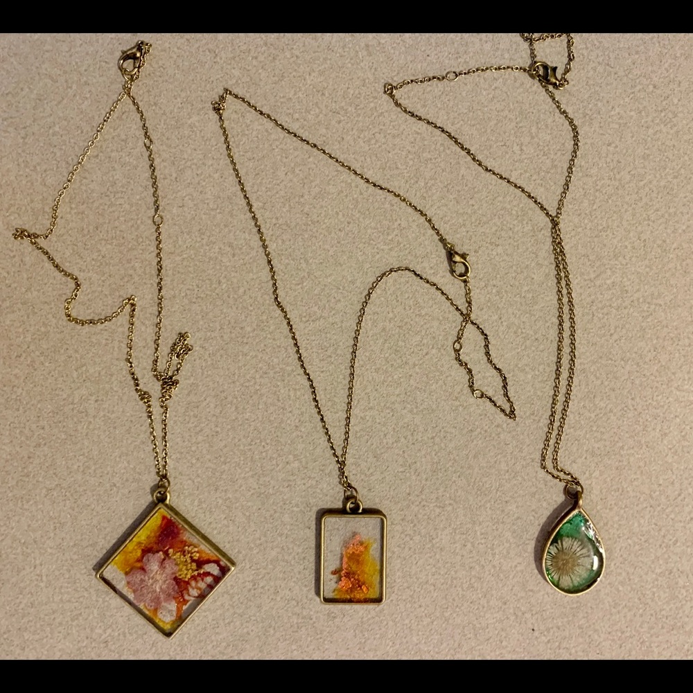 Handmade and painted resin necklaces.